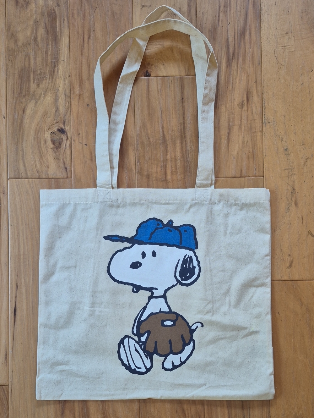 Peanuts Snoopy Cream Tote with Blue Baseball Hat and Brown Glove Graphic